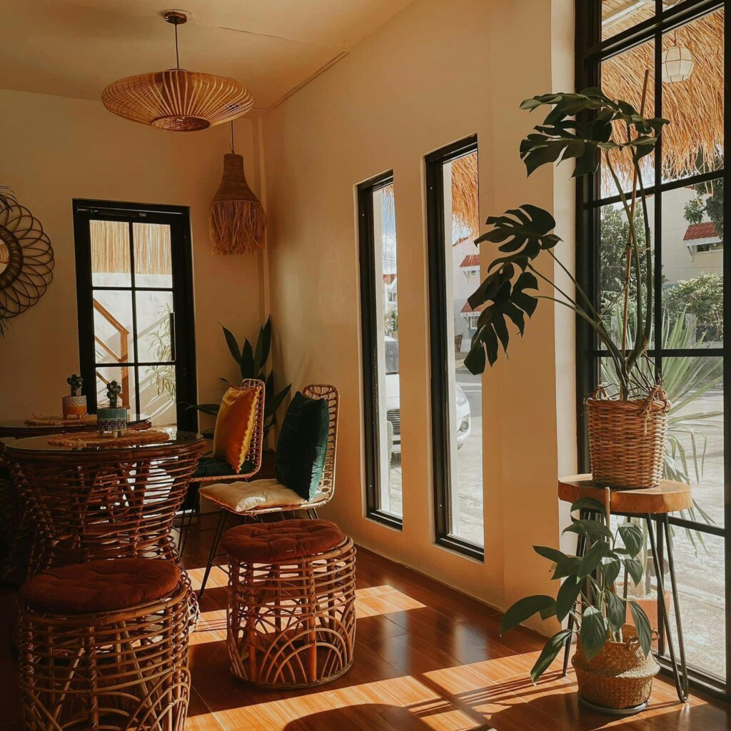Sunlit interior featuring cozy boho design with rattan furniture and houseplants.